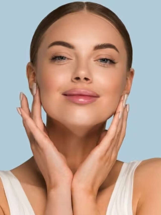 Woman showcasing glowing skin while applying skincare, emphasizing K-beauty routines and beauty rituals.