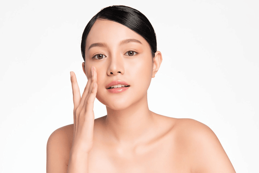 Woman applying skincare product to her face for healthy and radiant skin.