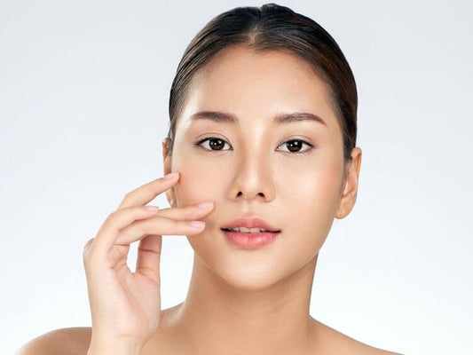Woman demonstrating radiant glass skin, showcasing healthy and glowing complexion.
