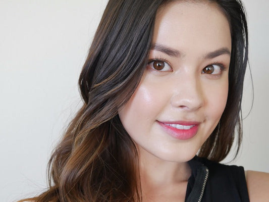 Smiling young woman with radiant skin showcasing results from Riman Incellderm Collagen 100 Melting Sheet Mask.