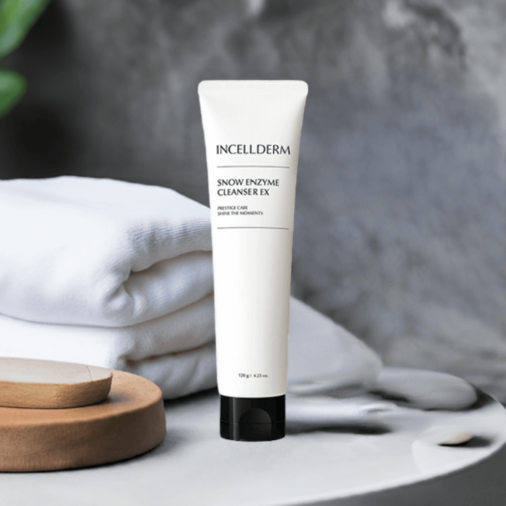 Incellderm Snow Enzyme Cleanser EX in a stylish setting with towels, showcasing its gentle foaming cleansing properties.