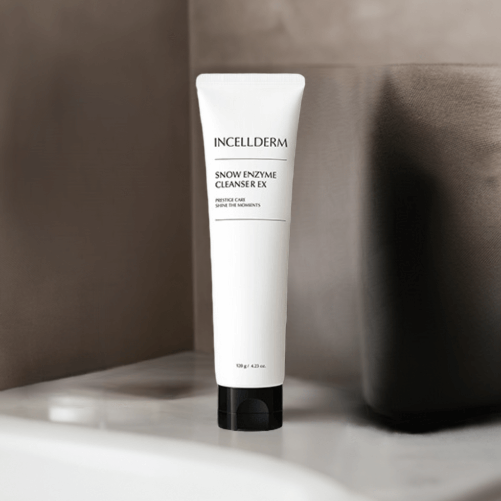 Incellderm Snow Enzyme Cleanser EX tube on a bathroom shelf, featuring a gentle foaming cream formula for skin care.