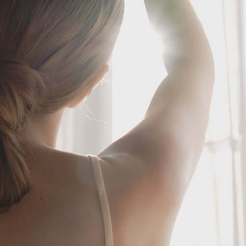 Woman showing Botalab Body Wash by Riman