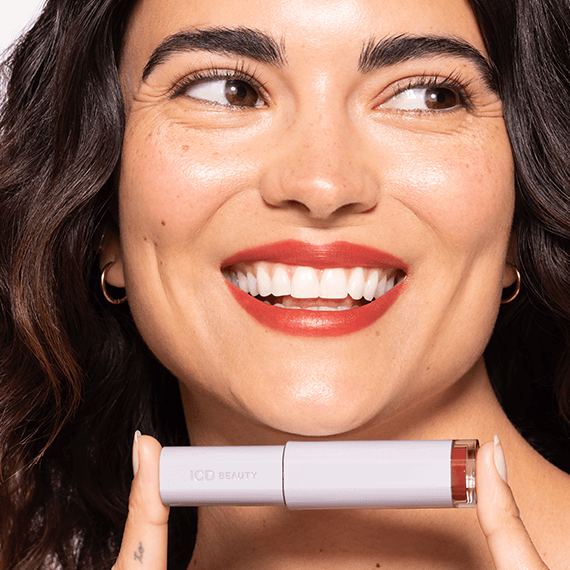 Smiling model showcasing ICD Makeup Butter Lip Tint Semi Matte for vibrant long-lasting color and lip care.
