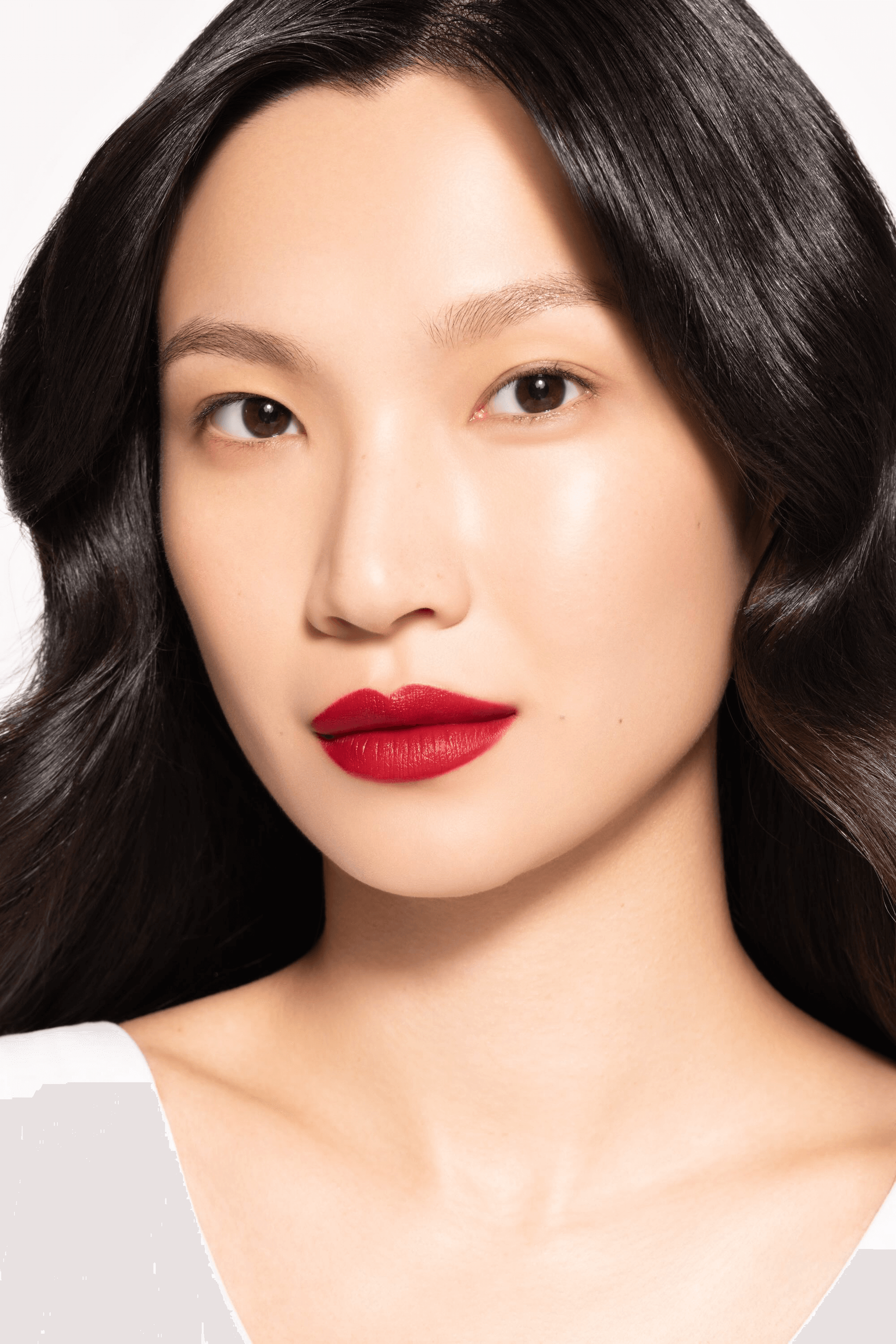 Model showcasing ICD Makeup Butter Lip Tint Velvet Matte in bold red shade, demonstrating lasting color and moisturizing texture.