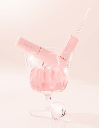 ICD Beauty Glow Up Lip Oil in a pink glass with jelly, showcasing moisturizing lip treatment and high-shine formula.