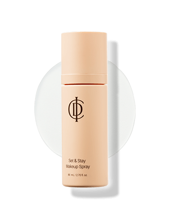 ICD Set & Stay Makeup Spray bottle on a circular background, perfect for locking in makeup with a refreshing mist.