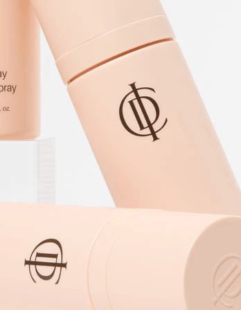 ICD Makeup Set featuring Stay Makeup Spray bottles with elegant design and brand logo in soft pink.