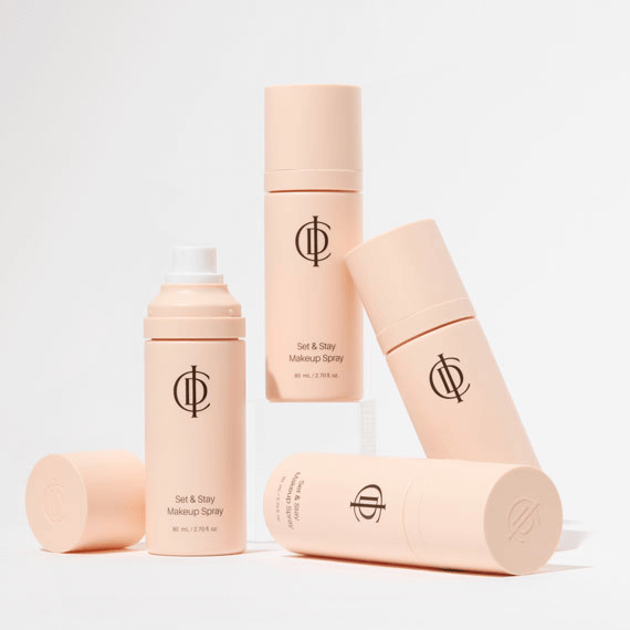 ICD Set & Stay Makeup Spray bottles in a stylish arrangement, ideal for setting makeup with a refreshing mist.