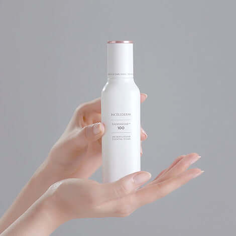RADIANSOME 100 Microfluidizer Essential Toner in a person's hands, showcasing its advanced anti-aging benefits.
