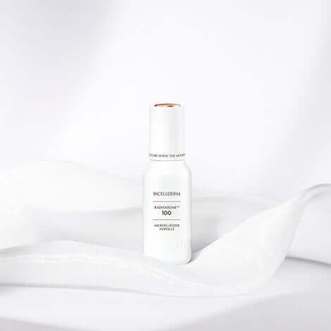 RADIANSOME 100 Microfluidizer Ampoule on soft fabric, designed for hydration and anti-aging benefits.