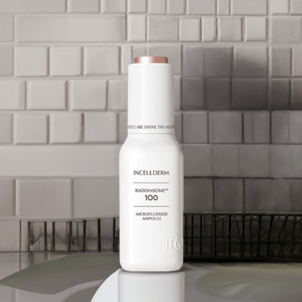 RADIANSOME 100 Microfluidizer Ampoule bottle on a tiled surface, showcasing hydrating anti-aging skincare.