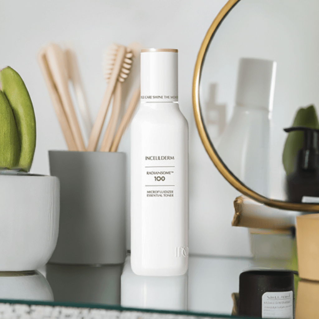 RADIANSOME 100 Microfluidizer Essential Toner bottle on a bathroom shelf with beauty products.