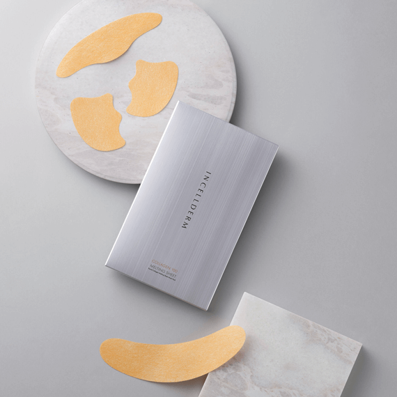 ICELLDERM Collagen 100 melting sheet mask with hydrating eye patches on marble surface.