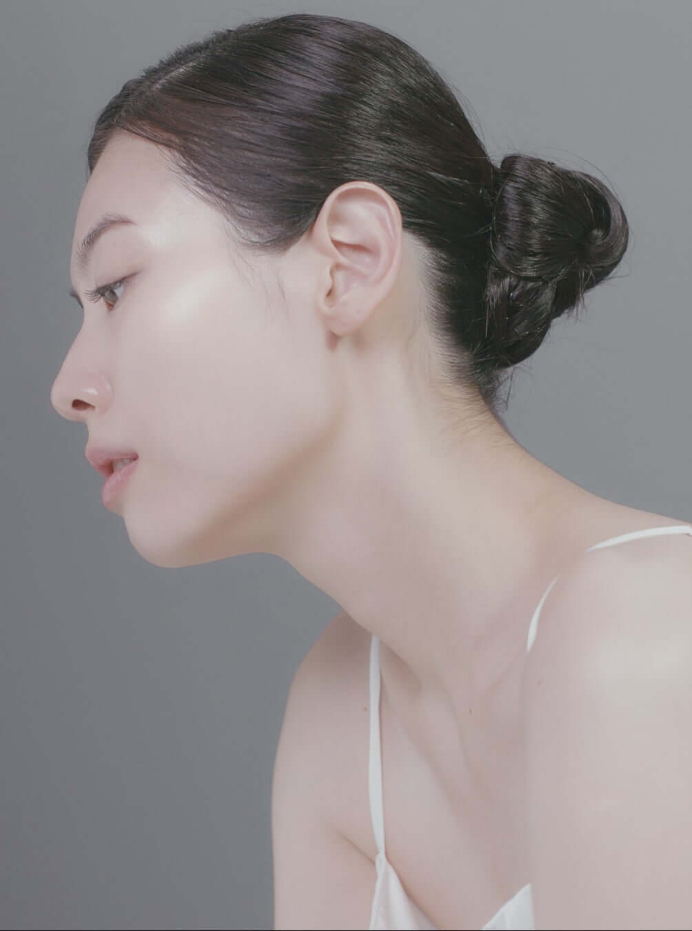 Profile view of a woman showcasing healthy, glowing skin, ideal for displaying skincare benefits.