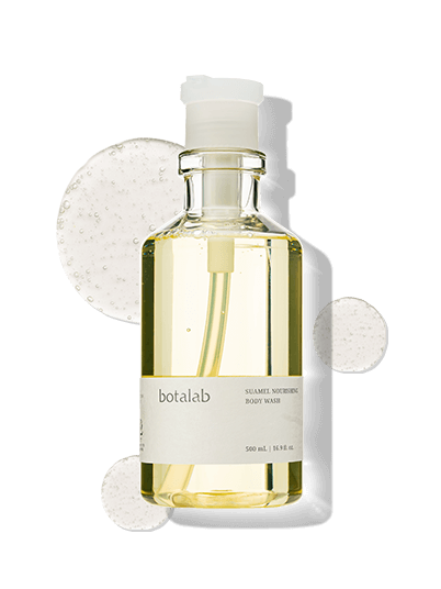 Close-up shot of Suamel Nourishing Body Wash bottle with clear gel swatches – gentle exfoliating body cleanser