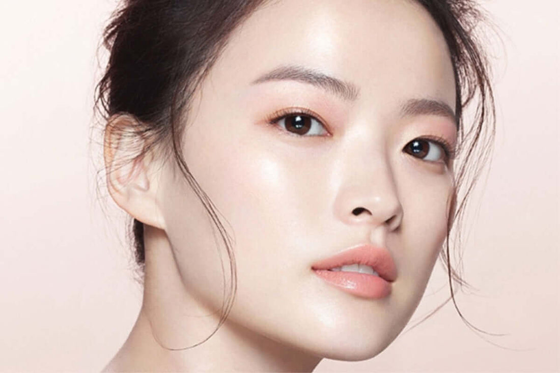 Close-up of a woman with glowing skin showcasing Korean beauty and skincare techniques.