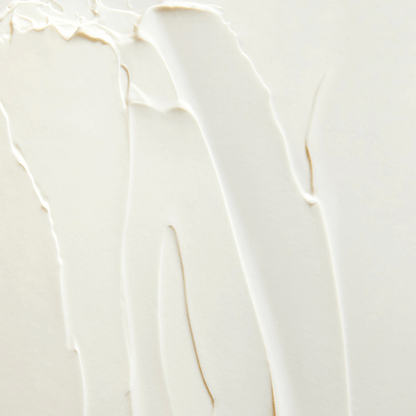 Textured close-up of white moisturizer, showcasing smooth application for skin hydration.
