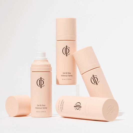 ICD Makeup Set & Stay Makeup Spray bottles arranged aesthetically on a light background.