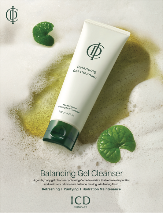 A tube of ICD Skincare Balancing Gel Cleanser is shown on a white background with decorative green lily leaves and a yellow-green liquid splash. The product packaging is white with a dark green cap and green logo.